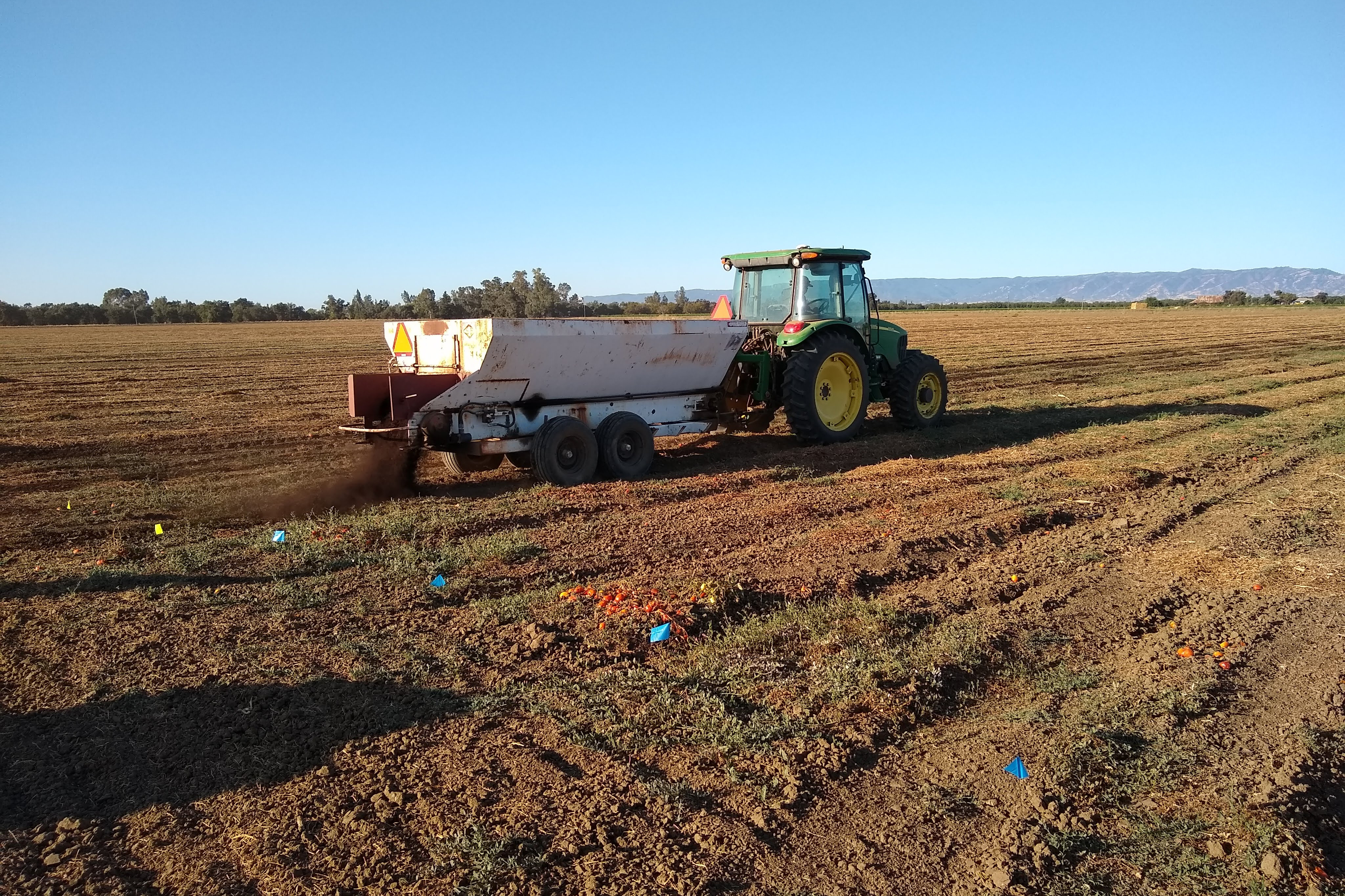 Compost is spread on a research field. (Courtesy UC Davis)