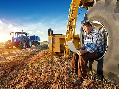 farmer_on_laptop_broadband_precision_ag.jpg