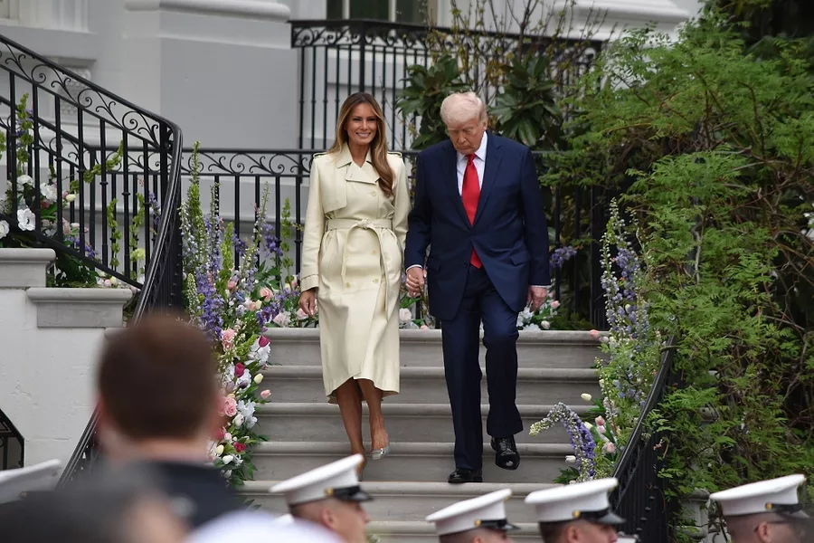 The Trumps walk down the staircase as The President's Own United States Marines Band plays.jpg