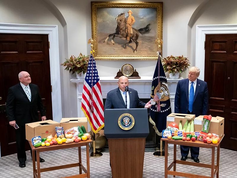 Zippy Duvall speaks as Sonny Perdue and Donald Trump look on