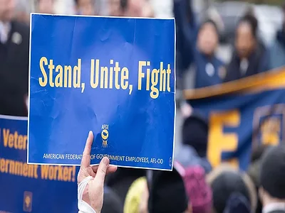 AFGE-hand-holding-protest-sign.jpg